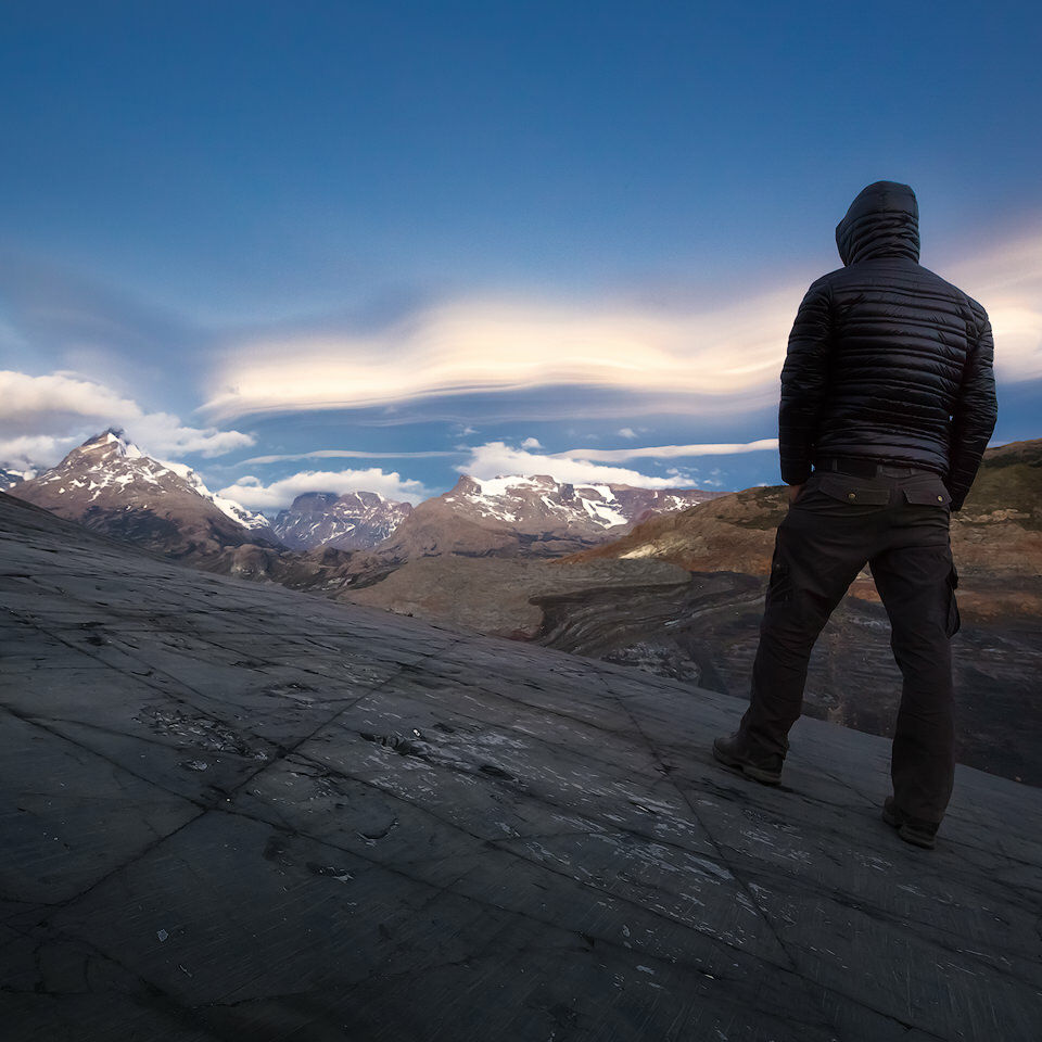 Joerg Bonner looking at mountains and a huge lenticular cloud.